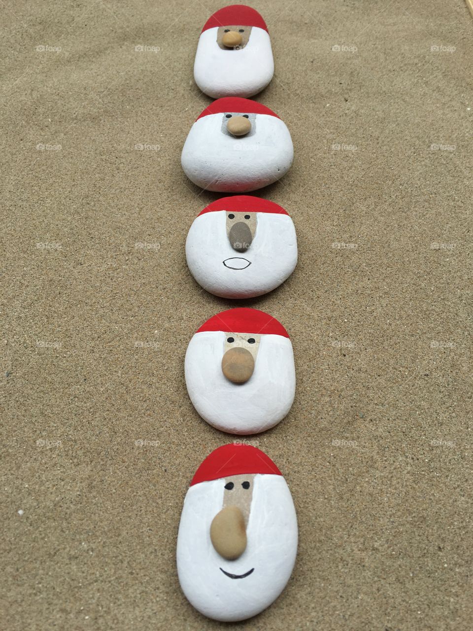 Many Santa Claus, art work on stones 