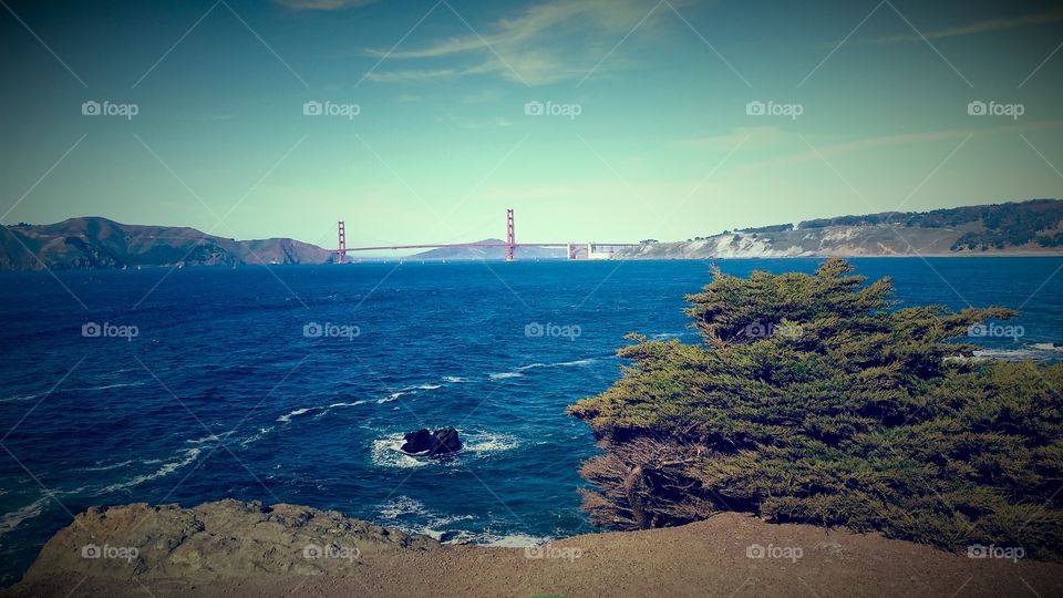 Golden Gate Bridge SF Bay. Vermillion hands reaching for the sky, a modern marvel.