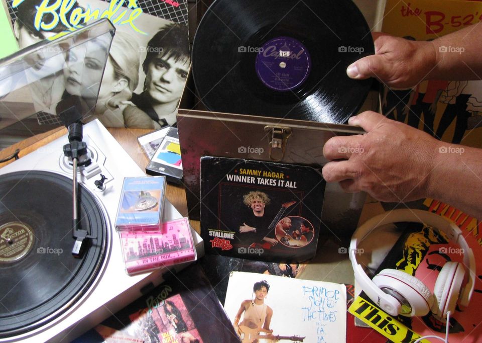 Listening to all types of music. Albums, tapes, headphones and turntable. 