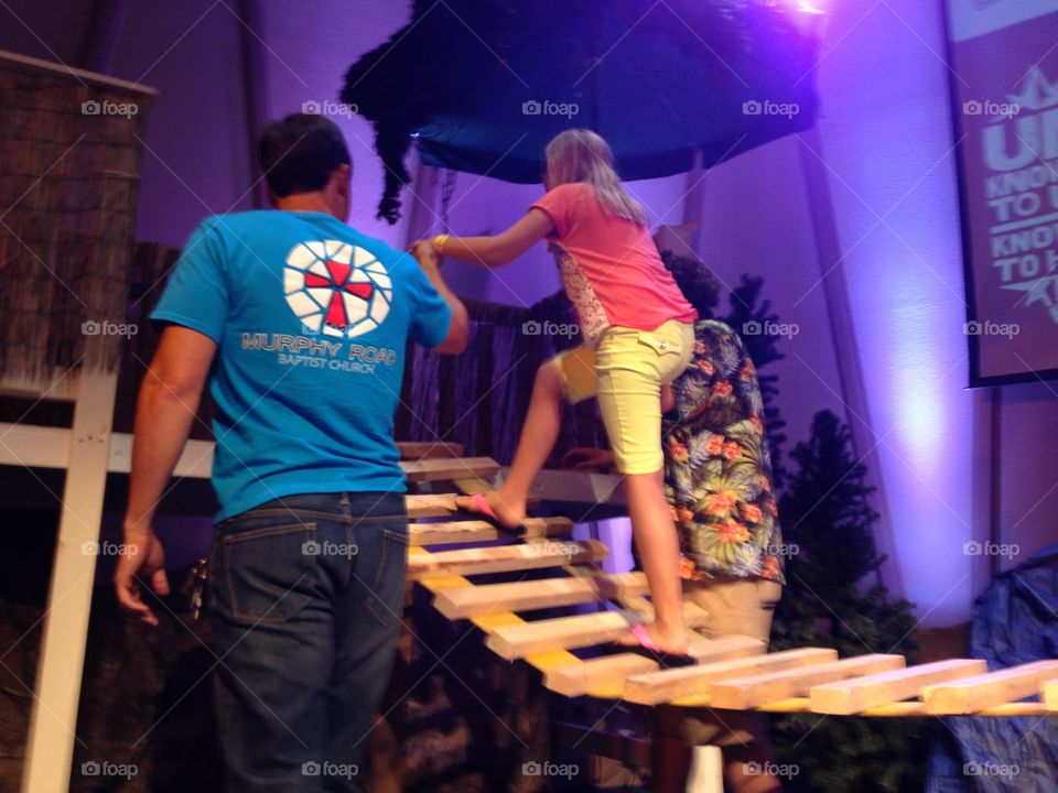 Bridge to VBS. Girl walking across Vacation Bible school bridge