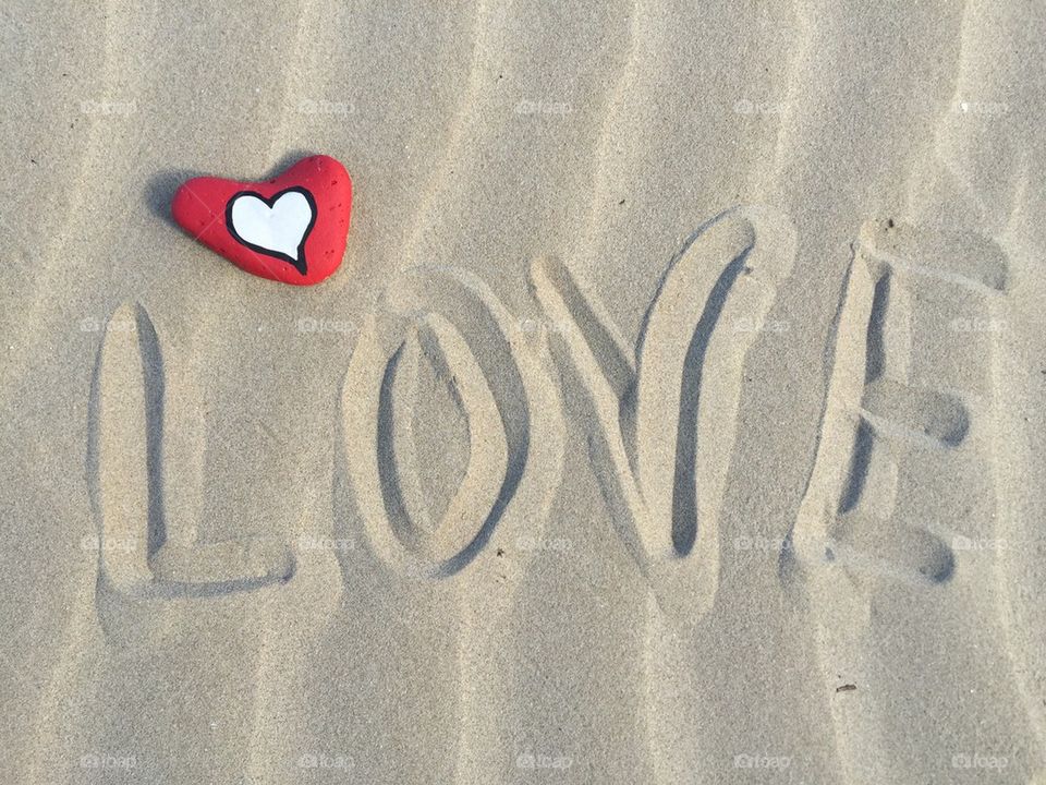 Love you concept on the sand with a heart