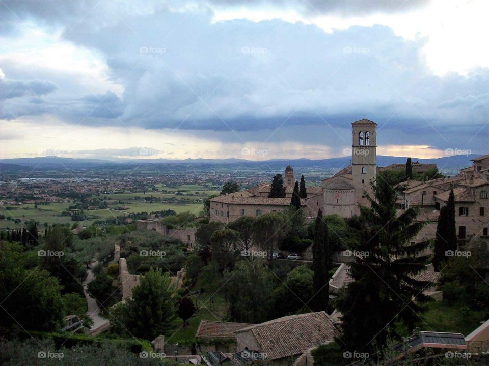 a stormy sunset behind peaceful Assisi