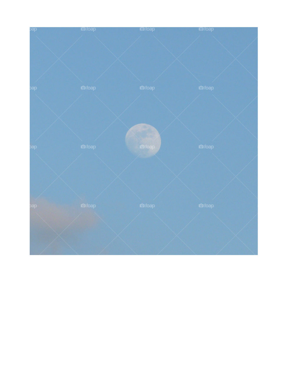 A blue sky and moon composition in a large white frame