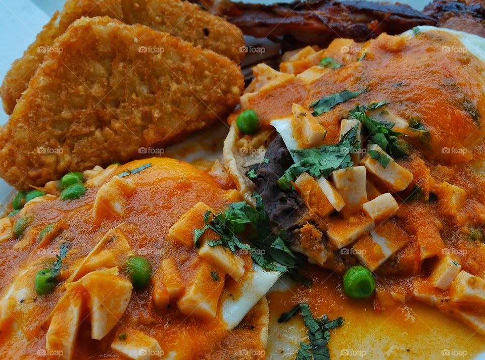 Breakfast In Mexico. Gourmet Mexican Breakfast Of Poached Eggs With Chili Peppers And Cotija Cheese
