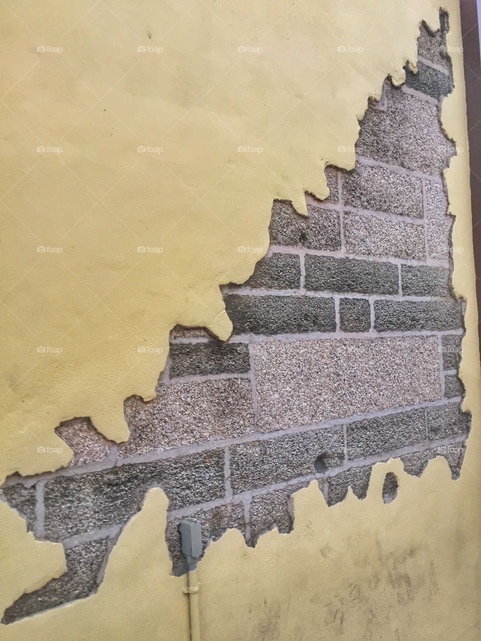 Behind the wall. An exposed brick wall