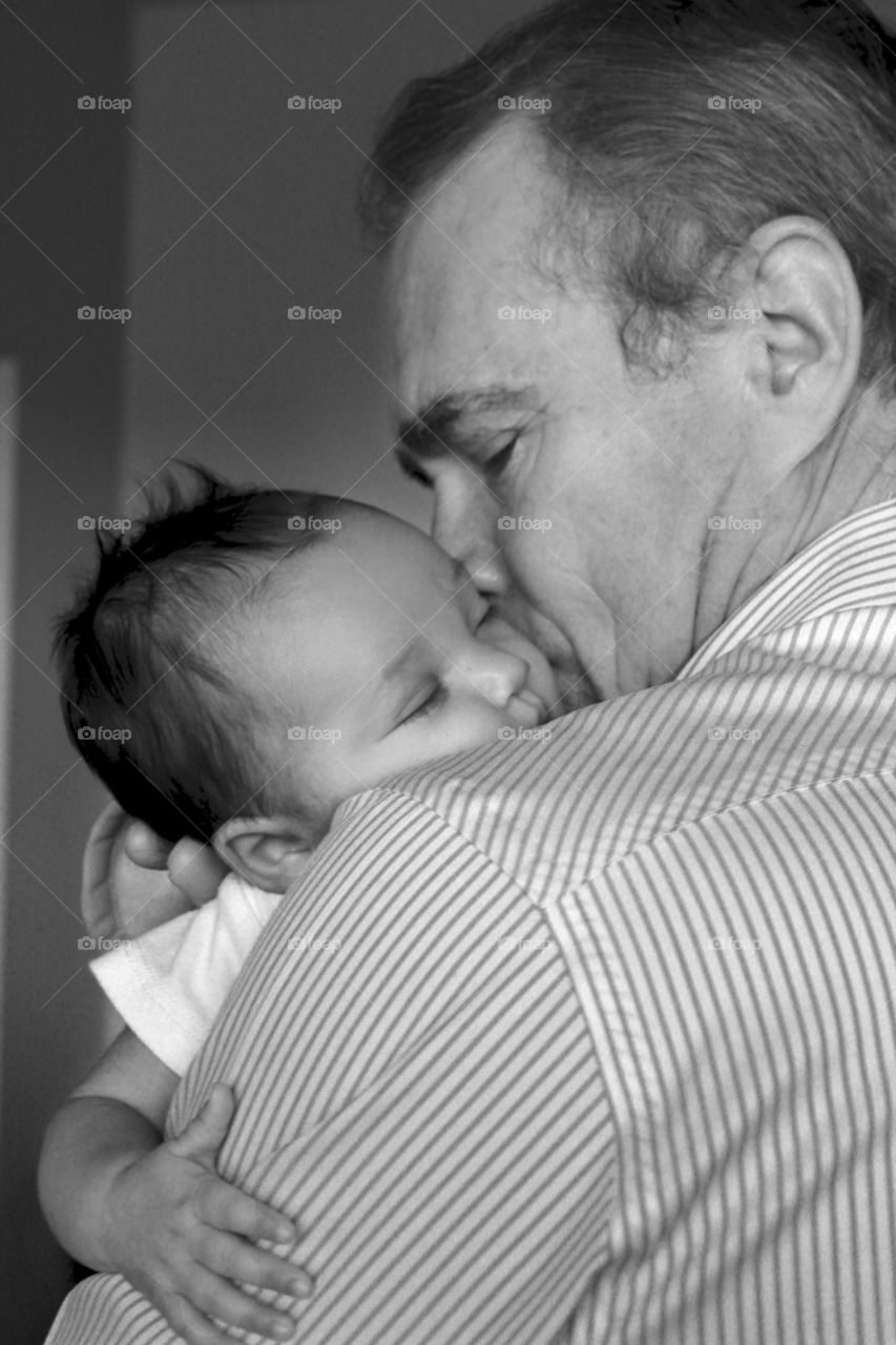 Close-up of a father kissing baby on her cheek