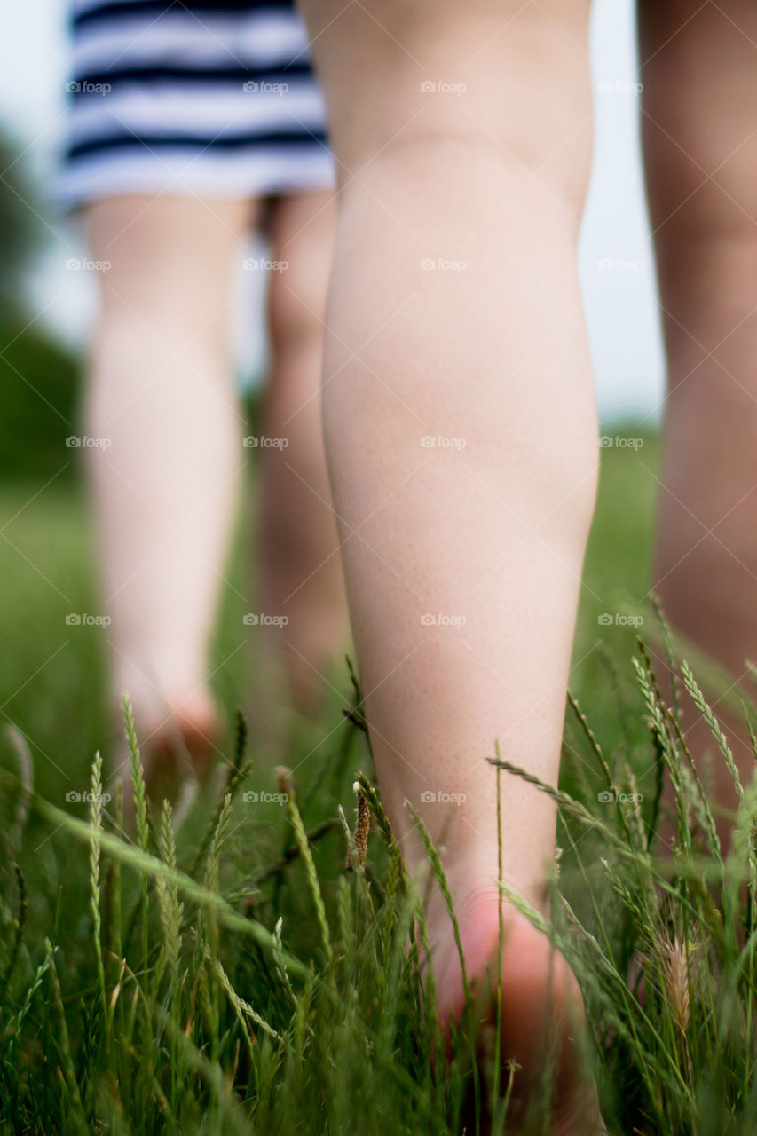 barefoot girls in grass. barefoot girls in short skirts walking on grass