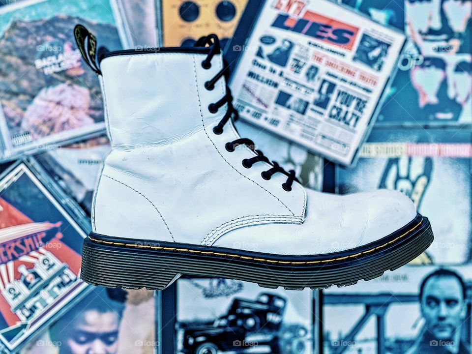 Doc Marten boot with classic music, CDs and DMs, Docs and music, musicians love Dr. marten boots, classic boots and classic music, retro vibes with boots and music, throwback boots and CDs, white Doc Marten boot and CDs