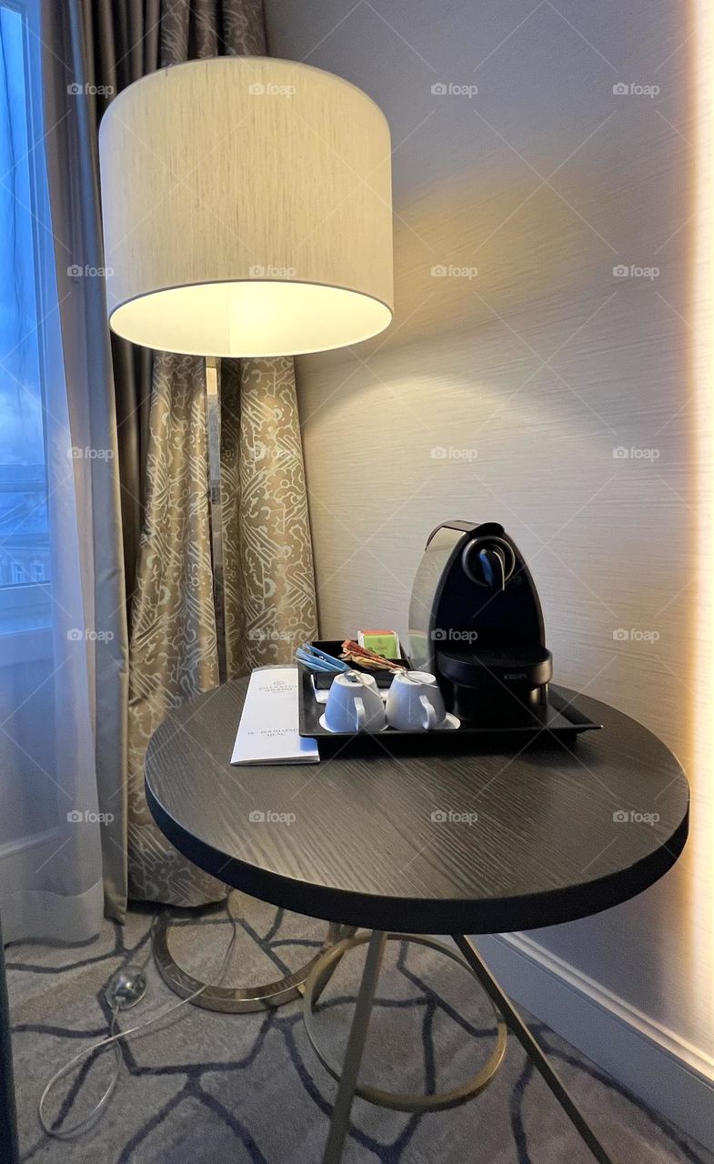 Table with coffee maker and cups