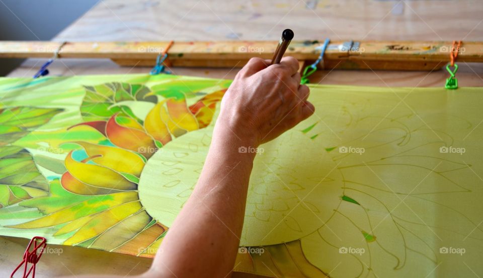 Woman painting on silk