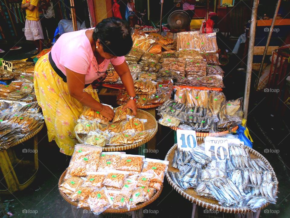 asian street vendor selling dried fish in quiapo, manila, philippines in asia