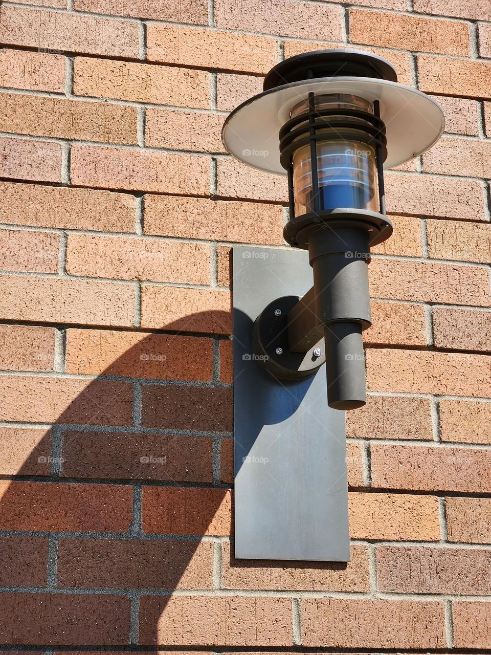 modern light fixture attached to brick wall