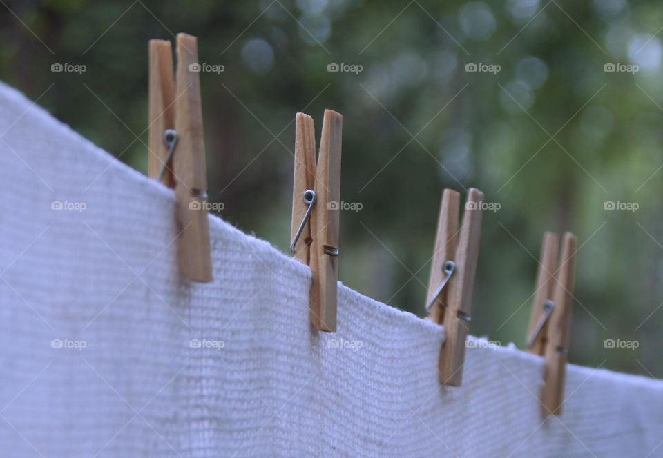 clothespins hang on a rope and clean linen is dried