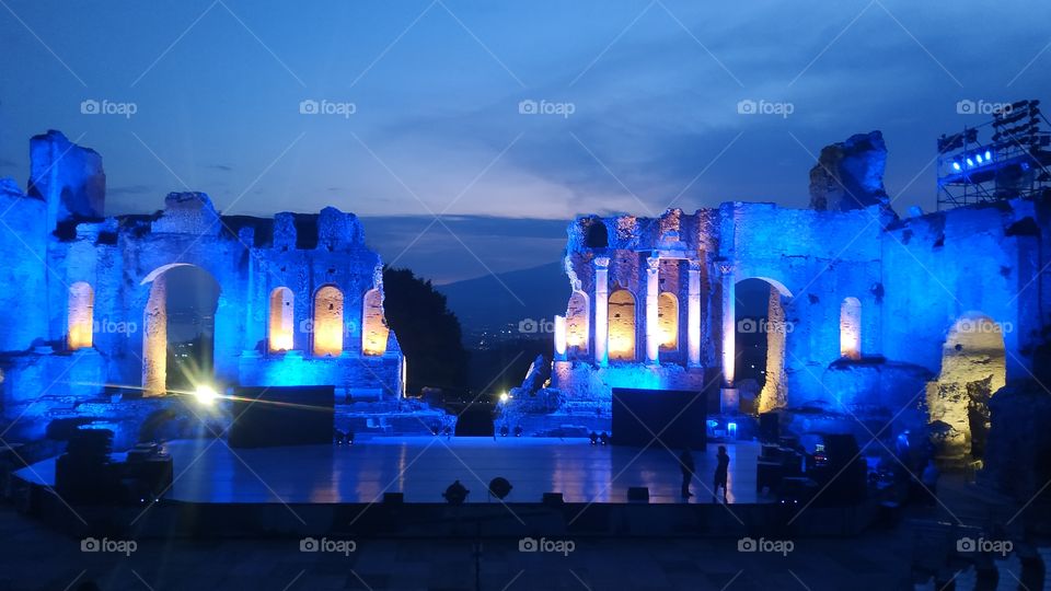 Taormina Teatro Antico - Messina - Sicily - Italy. Ancient Greek teathre near Catania. Lit by blue lights at dusk.