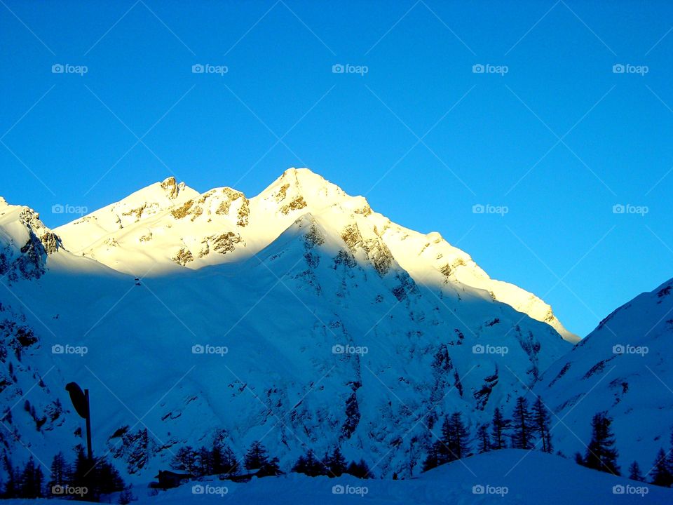 dawn over snowed peak of Mountain