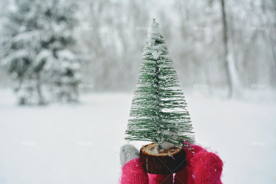 happy New year Christmas tree decorative in hand glove winter background