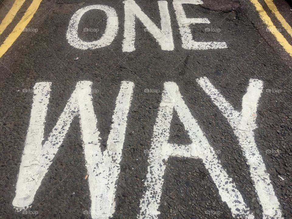 ‘One Way’ road marking and yellow lines off of St Albans Road, North Watford, Hertfordshire 