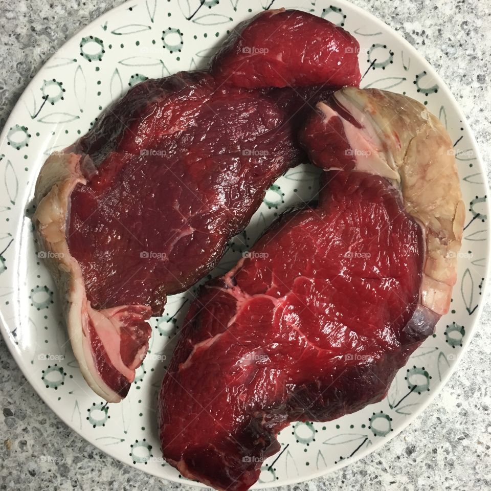 Two 8oz sirloin steaks ready to barbecue