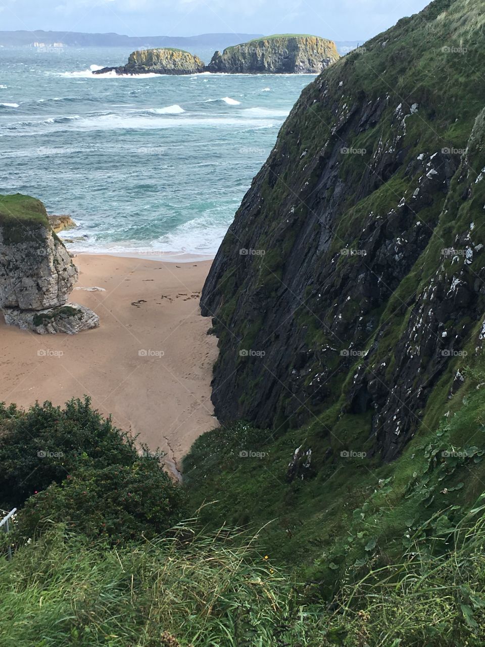 Looking down at a small beach from a cliff in Ireland 