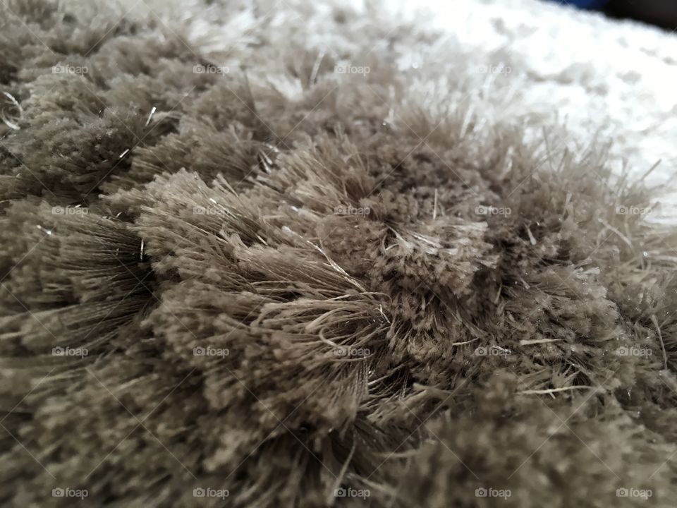 This shows a rug that has silver specs in it, and is a close up