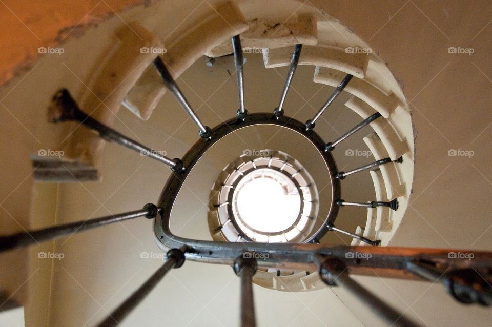 Looking up the center of a multistory spiral staircase