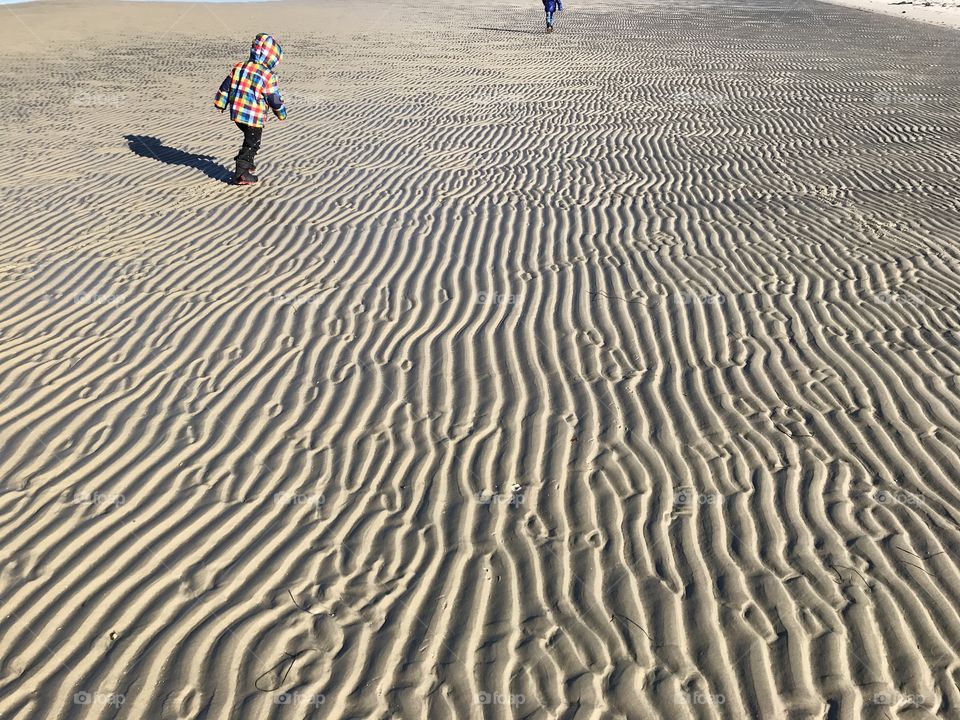 Kid and textured beach.