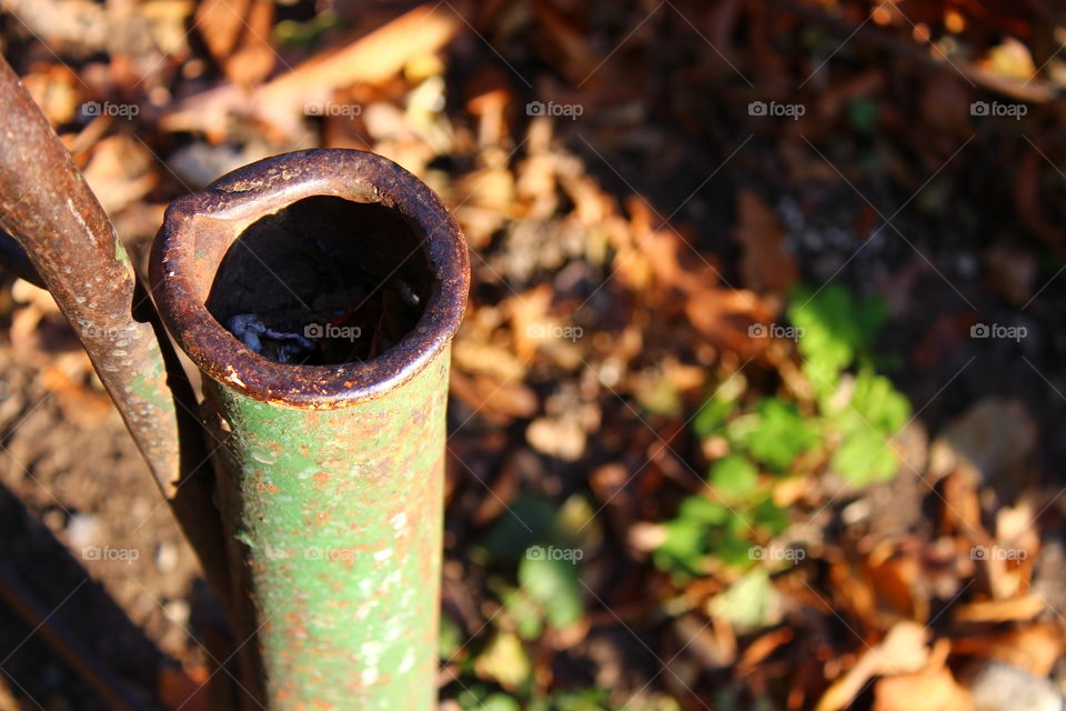 Autumn leaves and iron tube