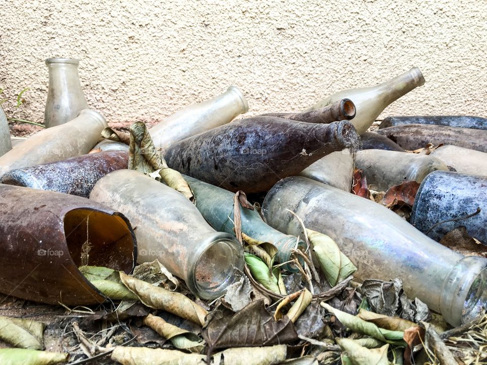 Antique old muddy dirty bottles, piled, some broken, closeup, grunge, steampunk, collectibles