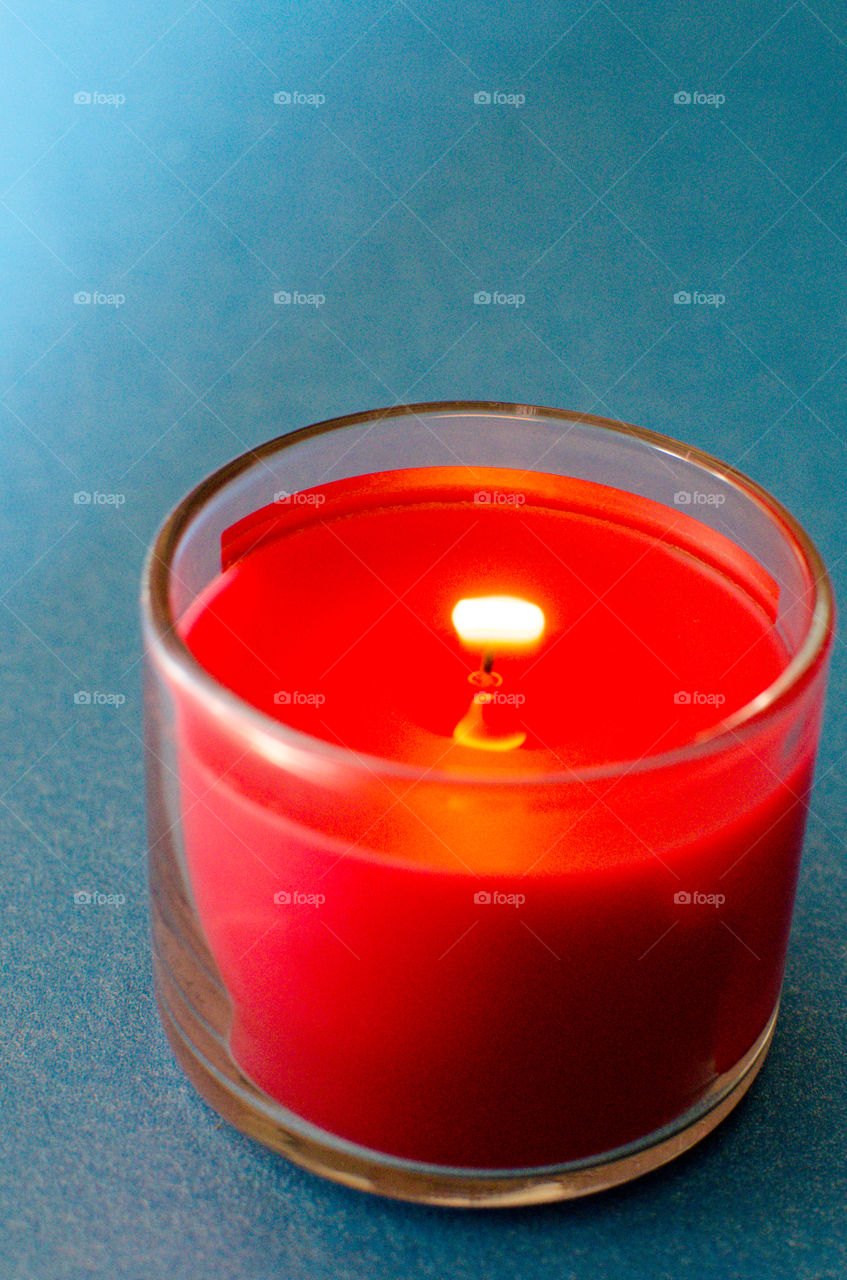 red candle on blue background