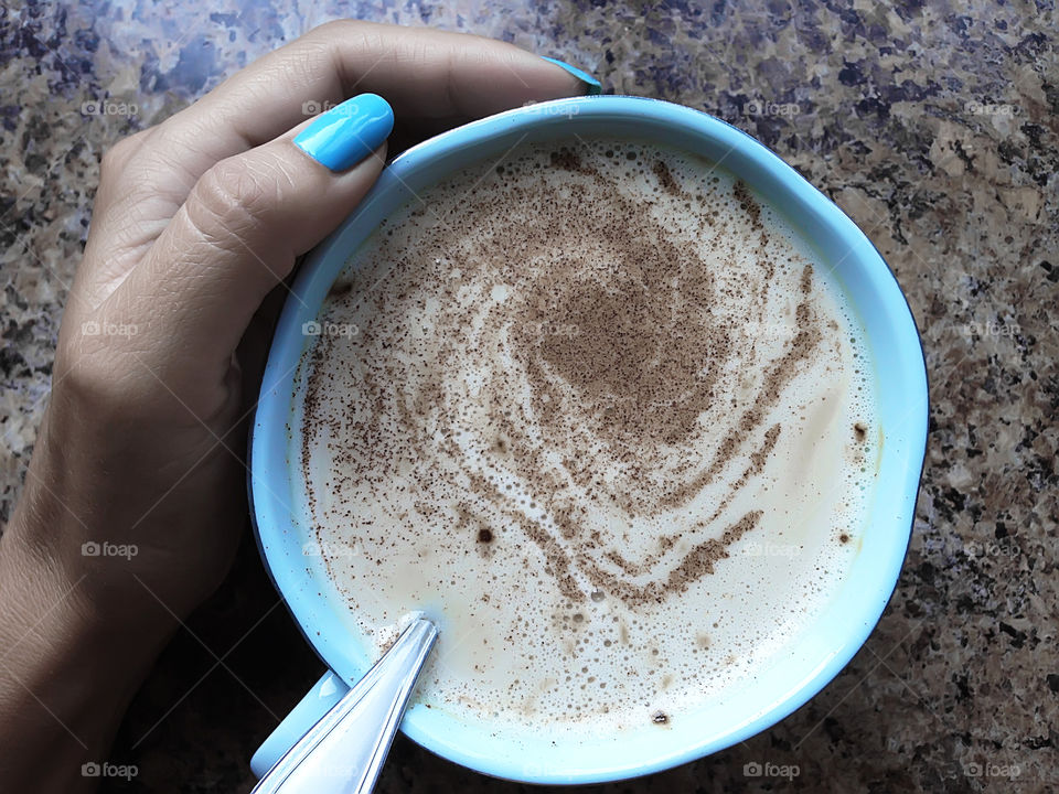 Blue coffee cup and manicure 