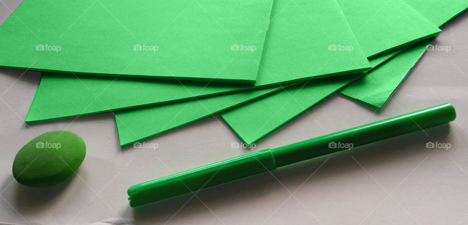 Green notebooks, pen and eraser