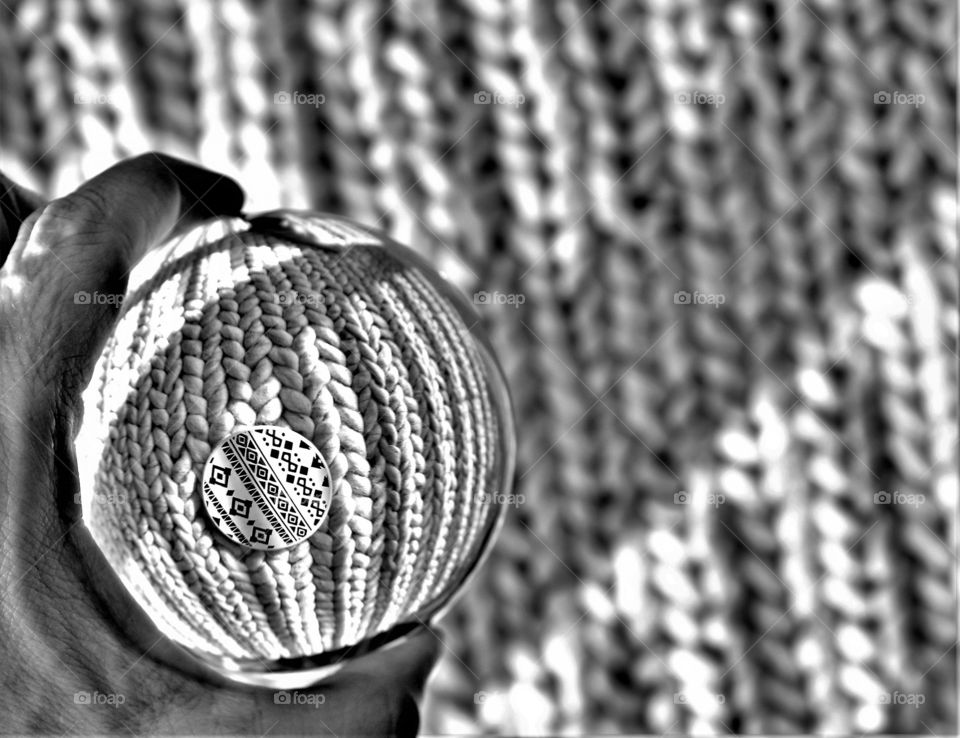 abstract black and white picture with crystal clear glass ball and abstract zigzag and knitted pattern