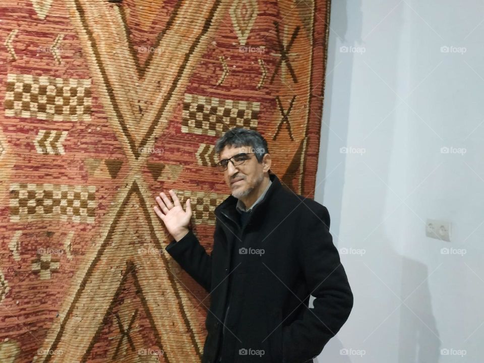 Im standing near an ancient moroccan carpet.