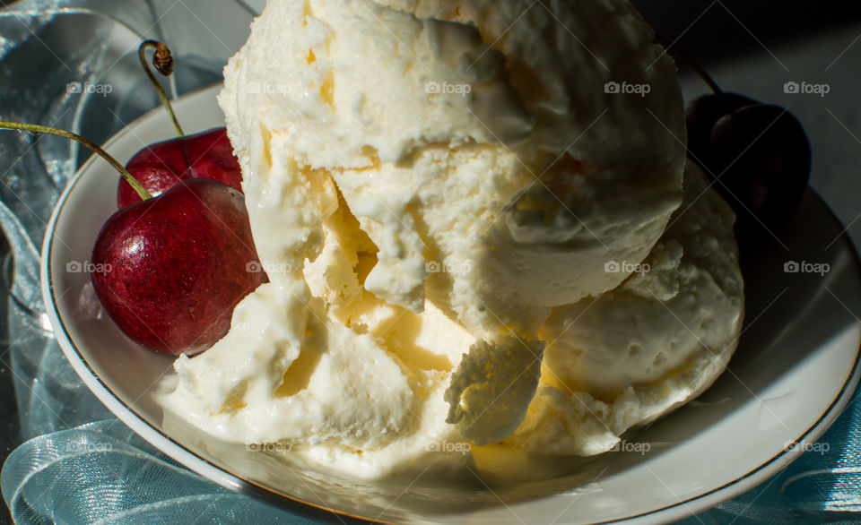 Fresh vanilla ice cream with fresh cherries in sunlight and shadows indulging in gourmet  summer dessert photography  background  