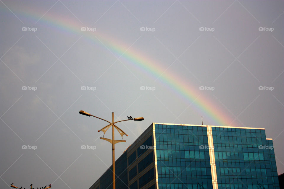 A rainbow over a building