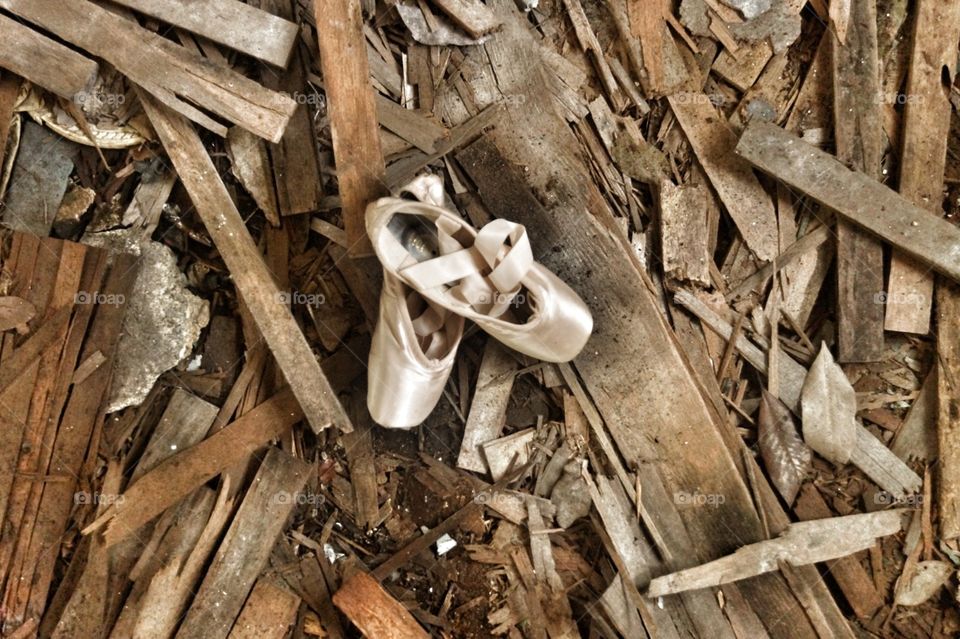 Ballet shoes in a pile of rusty wood