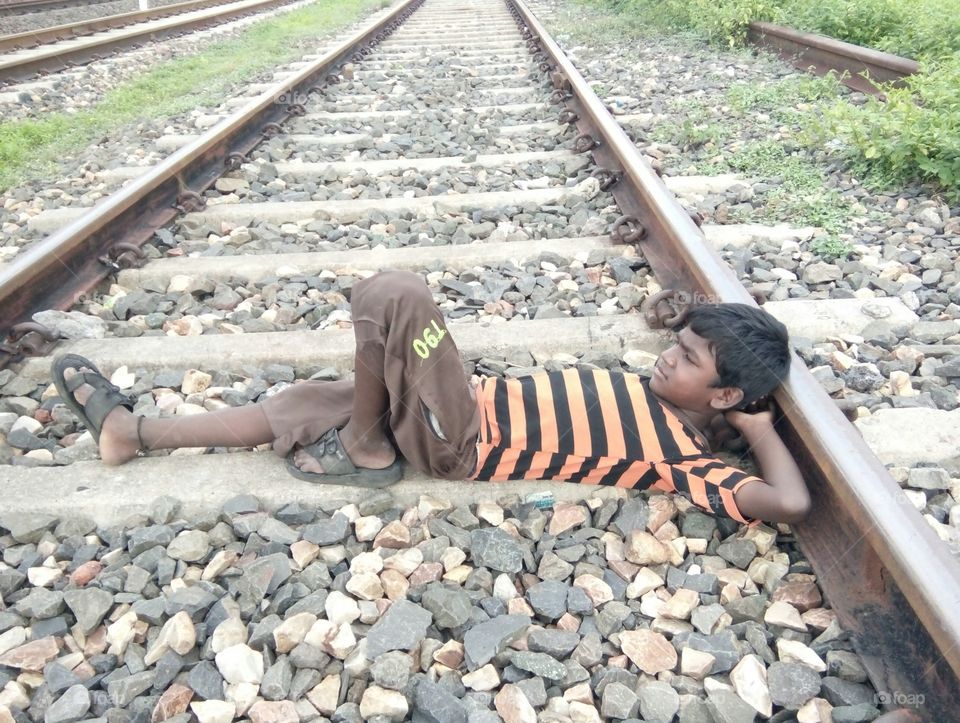 A photo lying on a boy railway line / a poor boy resting on a railway line, photo / boy resting in his style, photo / Indian style of resting photo / Hindustan style of taking photos / waiting photo / waiting for you  Photos taken/pleas do come I wai