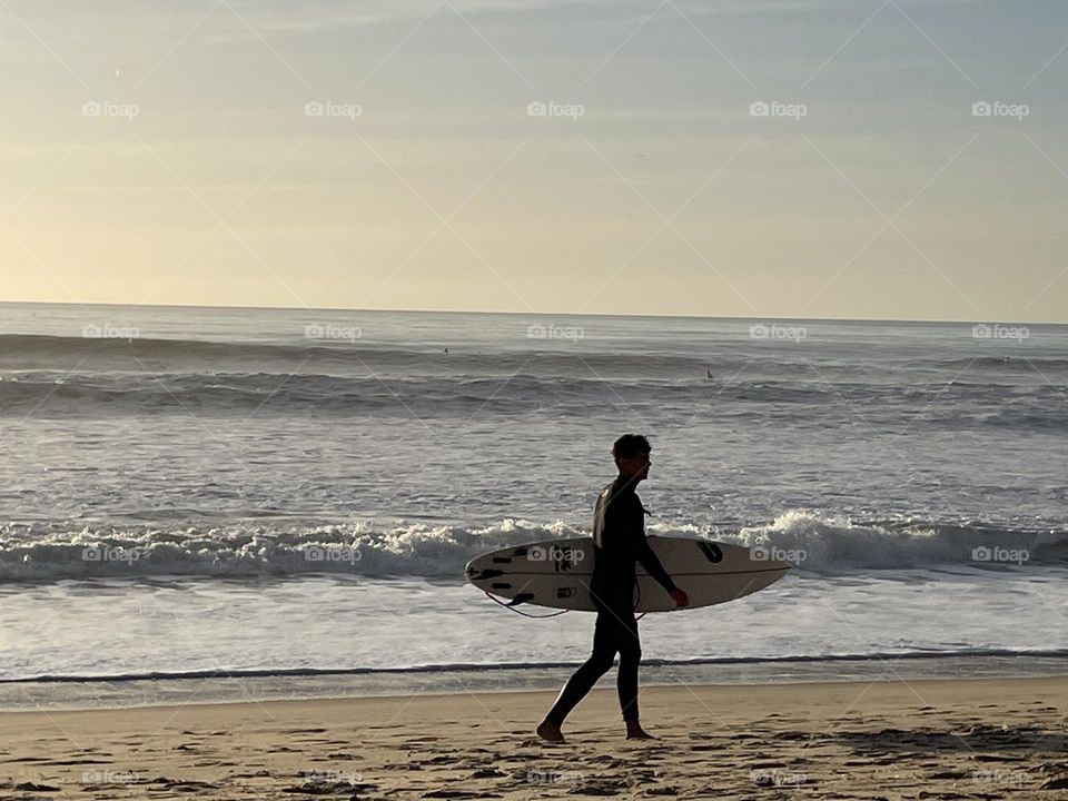 Boy at the beach with surfboard