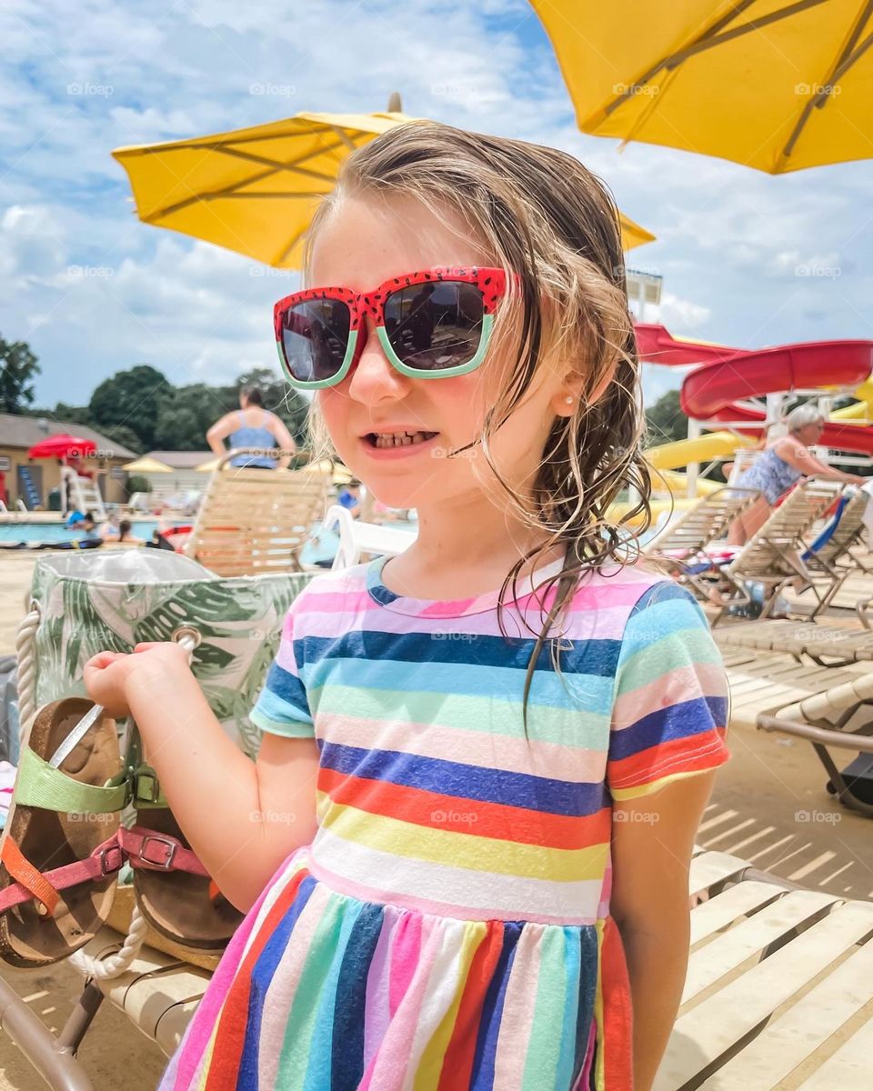 A sassy toddler by a pool