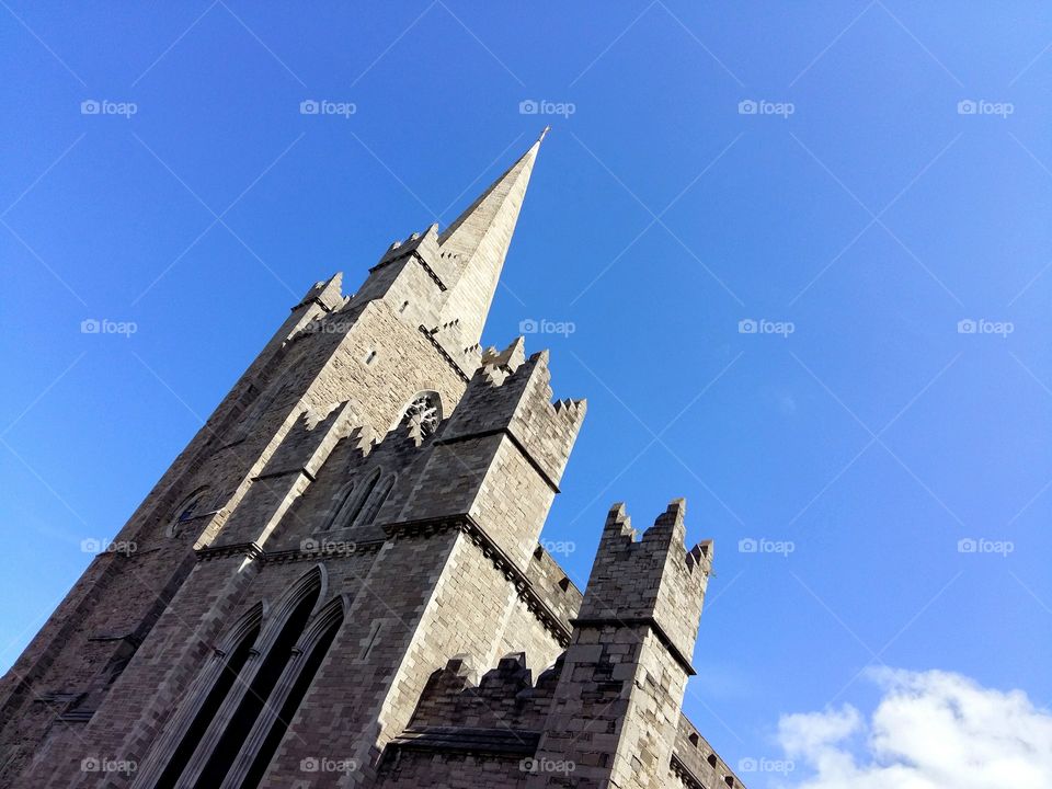 Church spire, in Dublin, against clear blue sky.