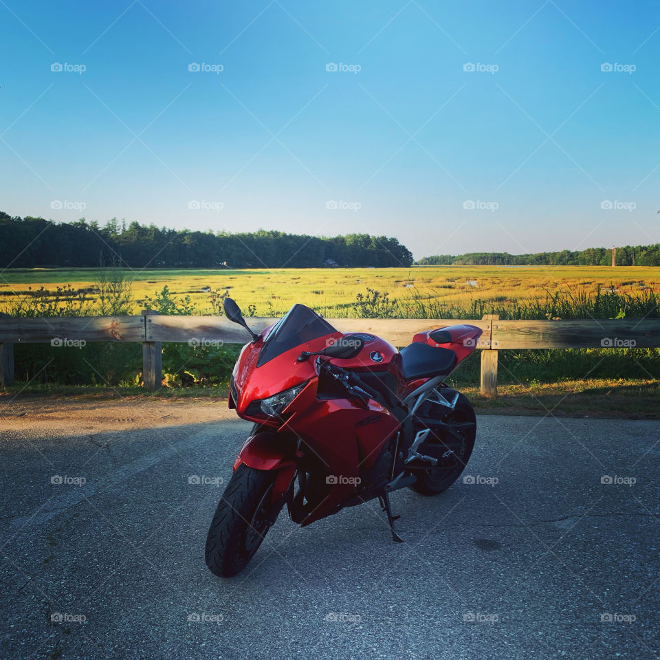 Honda CBR motorcycle with a sunset background over a river