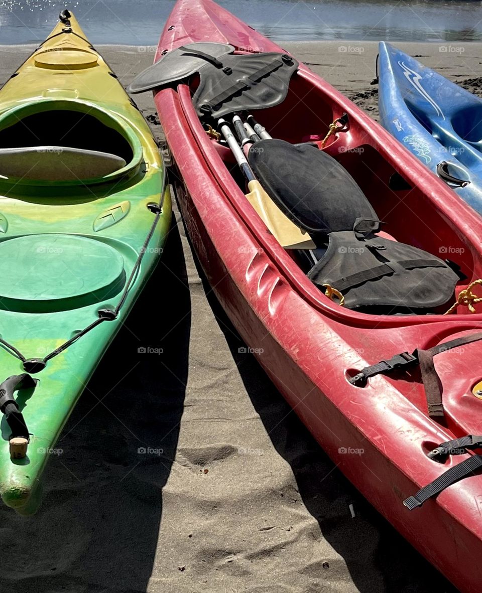 View of kayaks placed on the sand of the beach