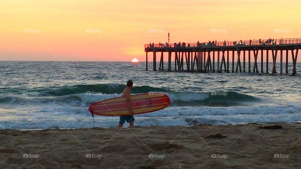 Surfer on Shore near pier at S