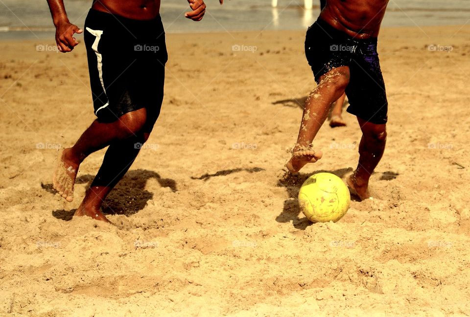 boys playing ball at itapua beach, Salvador, Bahia