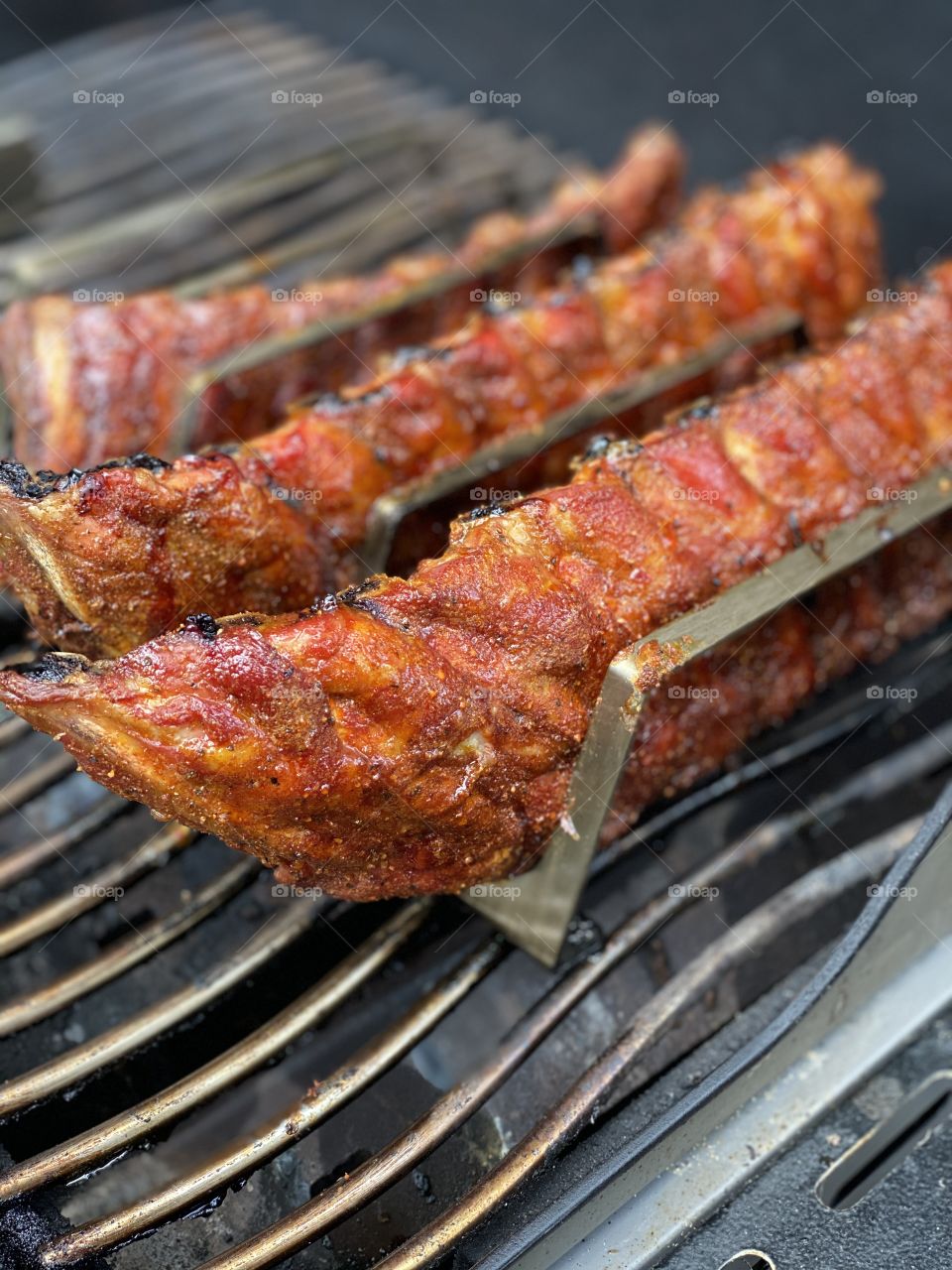 Barbecue with spareribs standing in a rack and homemade rub