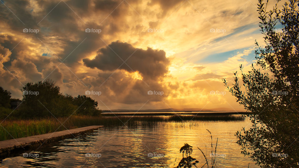 Sunset and dramatic cloudy skies over Corrib lake in Galway, Ireland