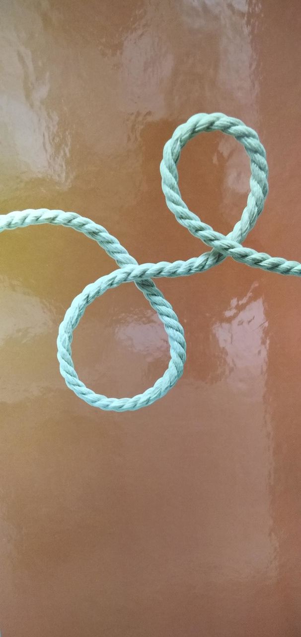 A picture of a piece of paper with a string on it