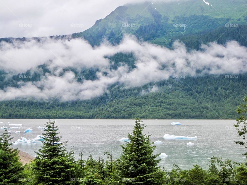 View in Alaska with clouds and mountains and water 