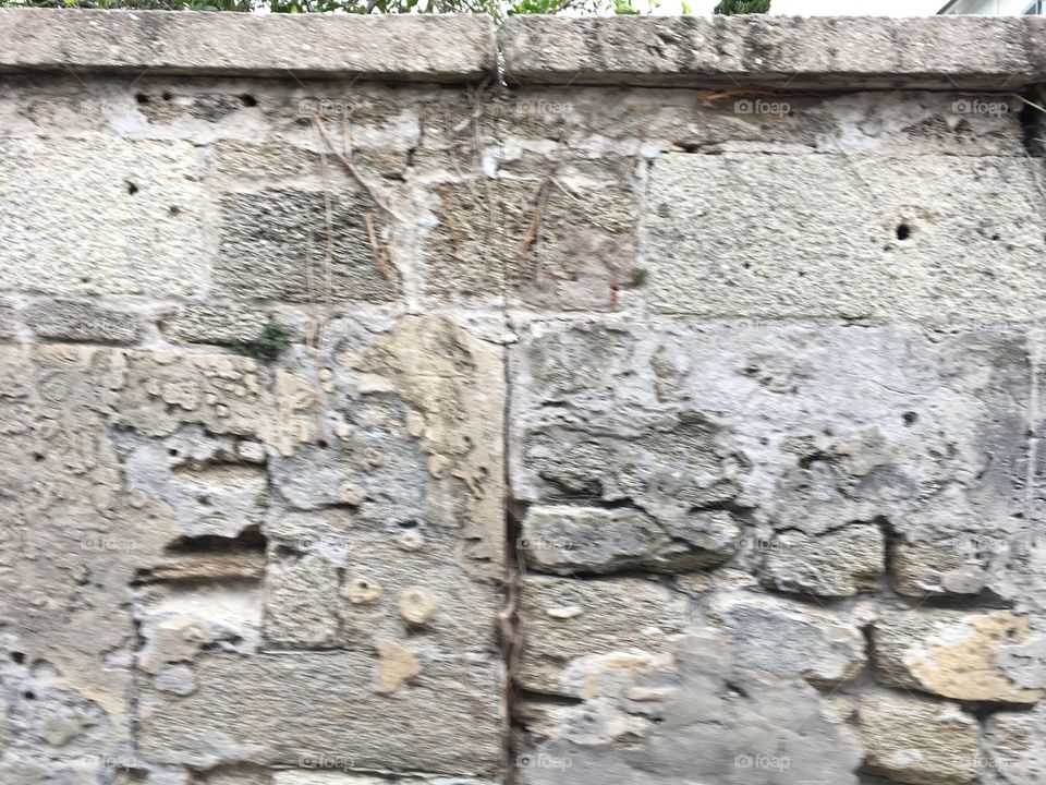Wall riddled with bullet and canon shot