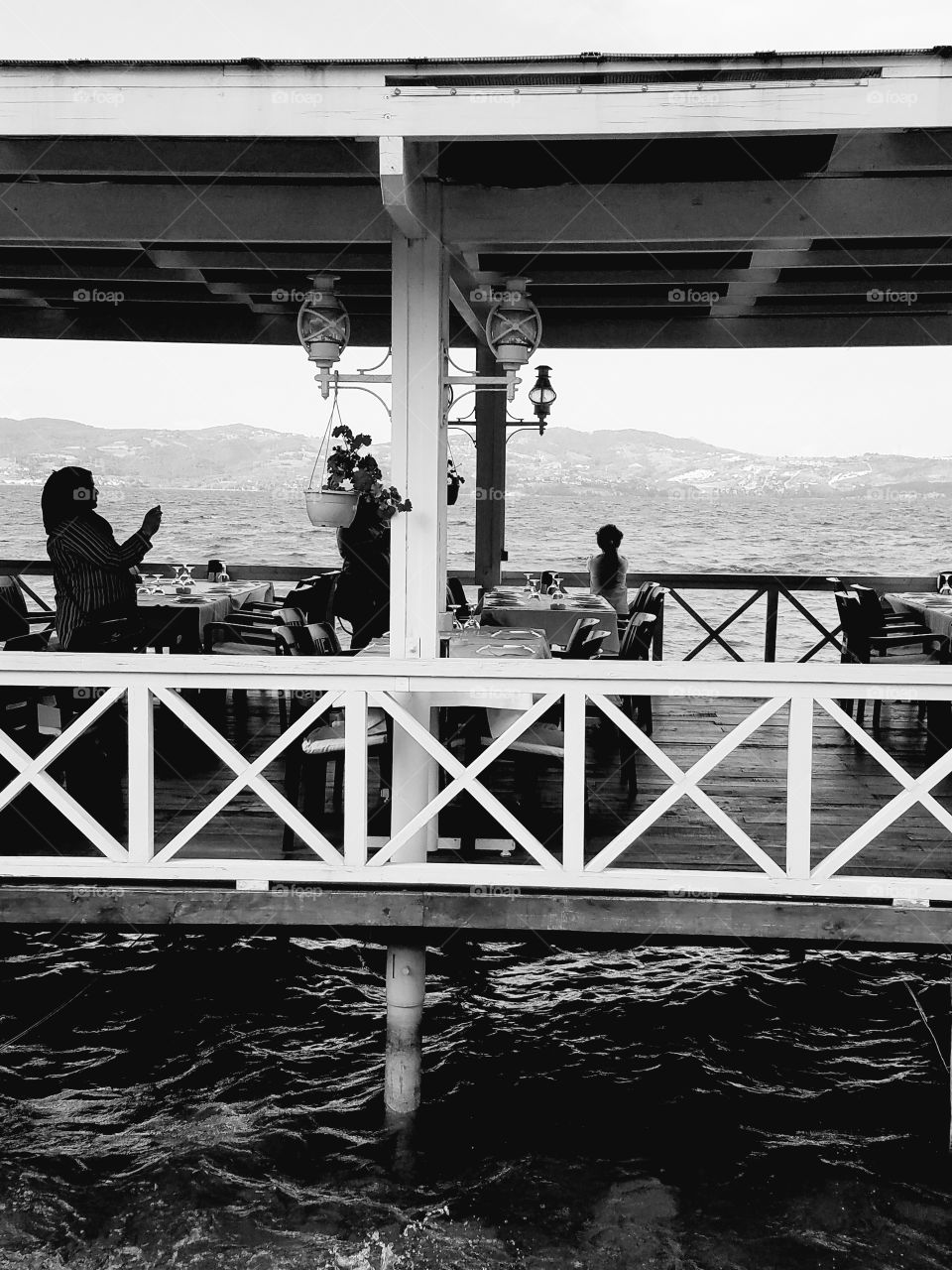 black and white photo of some people on a small restaraunt in the water in Sapanca Turkey
